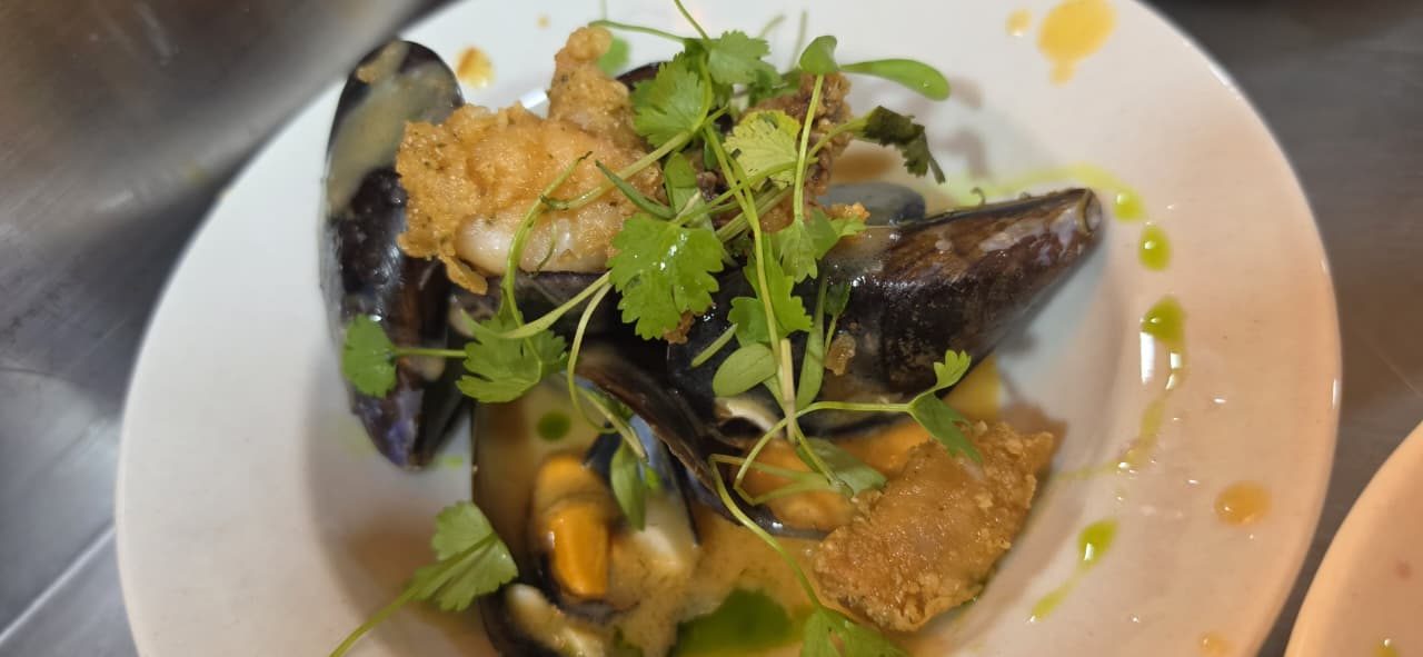 Steamed mussels with crispy tempura prawn and fresh coriander