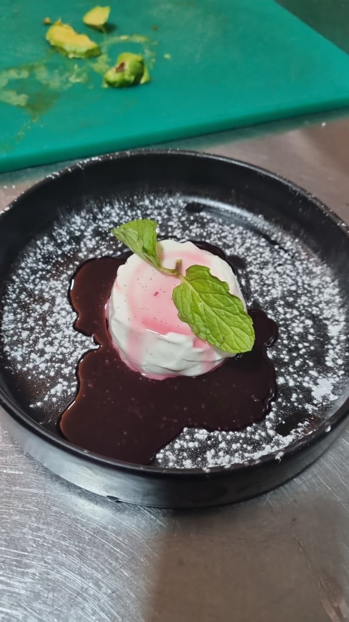 Vanilla panna cotta with berry coulis and mint