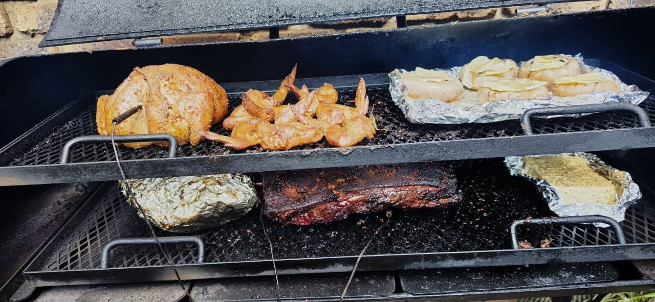 Whole chicken, wings, stuffed mushrooms and brisket in the smoker
