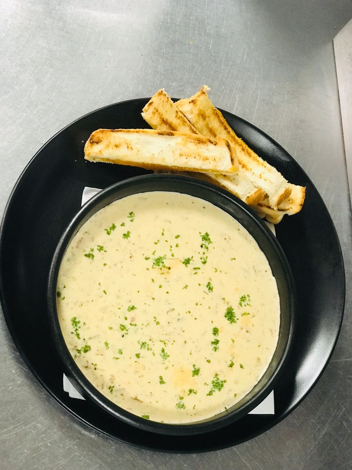 Creamy mushroom soup with parsley and grilled cheese soldiers